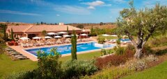 Bazén s lehátky a terasou u budovy v Monte Rei Golf & Country Club